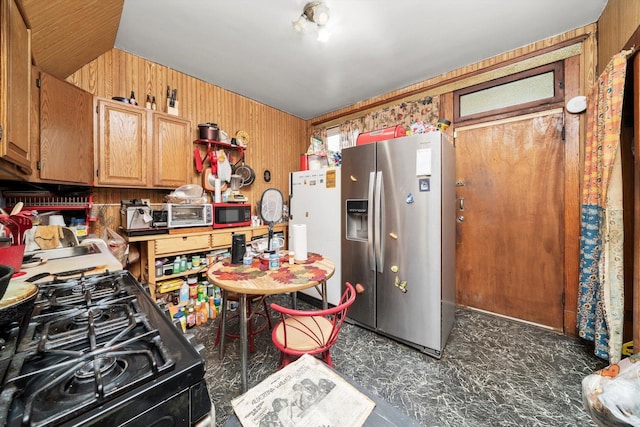 6108 S Honore St, Chicago, IL 60636 - kitchen featuring stainless steel fridge, black range with gas cooktop, wood walls, and freestanding refrigerator
