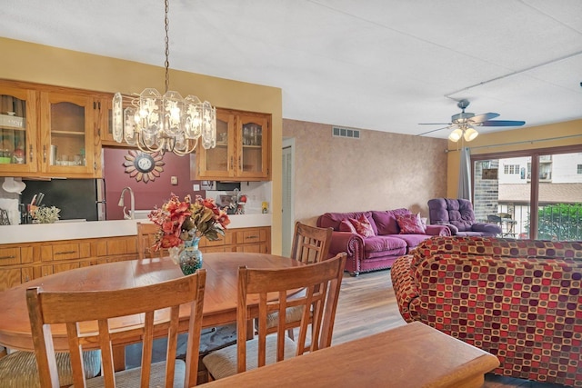 10528 Ridge Cove Dr Unit 11A, Chicago Ridge, IL 60415 - dining space featuring light wood-type flooring, a chandelier, and ceiling fan