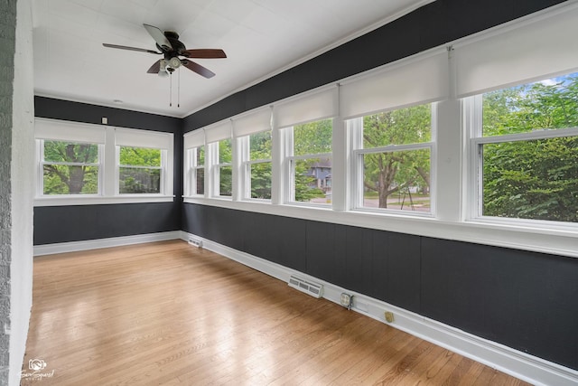 915 E Duane Blvd, Kankakee, IL 60901 - unfurnished sunroom featuring plenty of natural light, wood finished floors, and baseboards