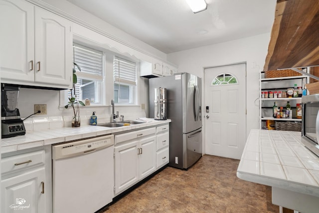 915 E Duane Blvd, Kankakee, IL 60901 - kitchen featuring white dishwasher, a sink, tile counters, and healthy amount of natural light