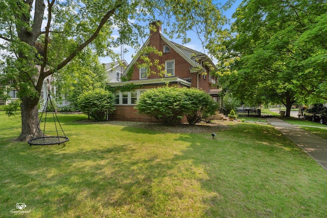 915 E Duane Blvd, Kankakee, IL 60901 - view of home's exterior with brick siding, a yard, and a chimney