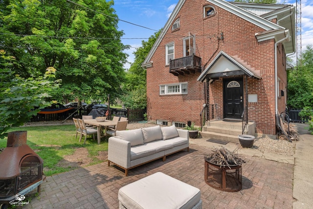 915 E Duane Blvd, Kankakee, IL 60901 - view of patio featuring a balcony, outdoor dining space, and an outdoor living space with a fire pit