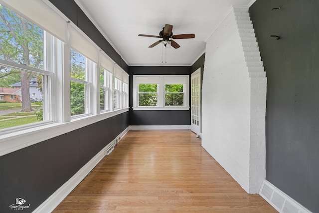 915 E Duane Blvd, Kankakee, IL 60901 - unfurnished sunroom featuring wood finished floors, ornamental molding, and baseboards