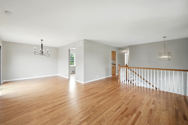 8306 Regency Ct, Willow Springs, IL 60480 - unfurnished room featuring a chandelier, light wood finished floors, baseboards, and a smoke detector