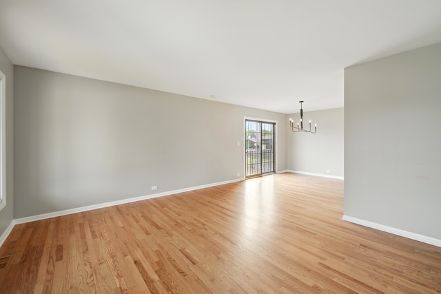 8306 Regency Ct, Willow Springs, IL 60480 - unfurnished room with a chandelier, light wood-style flooring, and baseboards