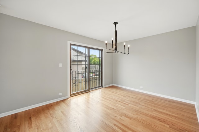 8306 Regency Ct, Willow Springs, IL 60480 - spare room featuring a chandelier, light wood-type flooring, and baseboards