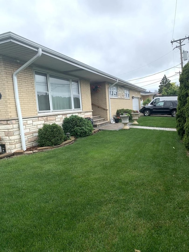 8500 W Winona St, Chicago, IL 60656 - view of front of house featuring a front lawn, brick siding, and stone siding