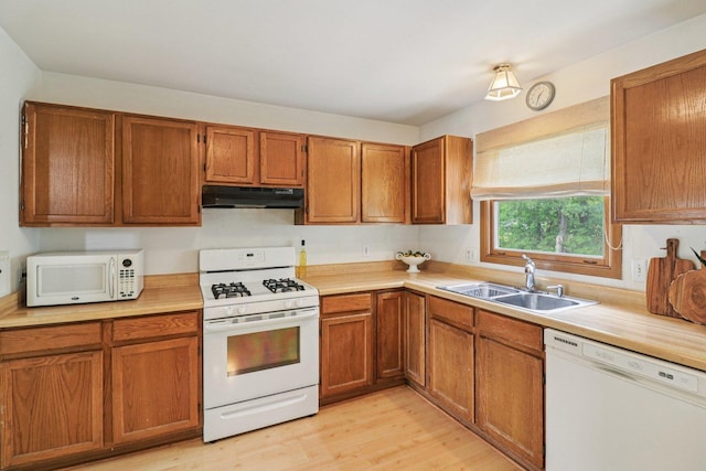 1705 N Donovan St, Mchenry, IL 60050 - kitchen featuring white appliances, under cabinet range hood, a sink, light countertops, and light wood-style floors