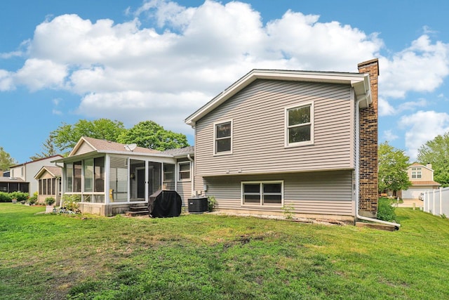 1705 N Donovan St, Mchenry, IL 60050 - rear view of property featuring a sunroom, a chimney, cooling unit, and a lawn