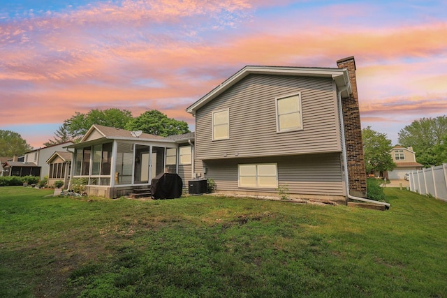 1705 N Donovan St, Mchenry, IL 60050 - rear view of house with a sunroom, a chimney, and central AC