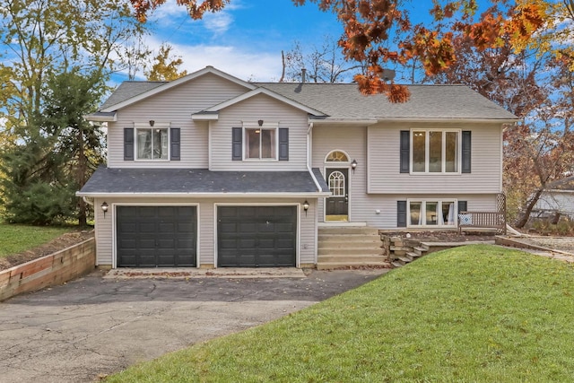 25911 W Highpoint Rd, Ingleside, IL 60041 - raised ranch featuring an attached garage, a front lawn, asphalt driveway, and roof with shingles