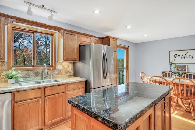 25911 W Highpoint Rd, Ingleside, IL 60041 - kitchen featuring appliances with stainless steel finishes, a sink, rail lighting, light wood finished floors, and plenty of natural light
