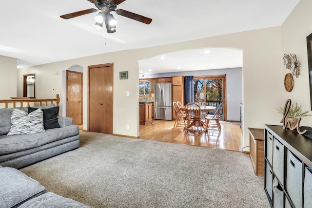 25911 W Highpoint Rd, Ingleside, IL 60041 - living room with arched walkways, light colored carpet, ceiling fan, recessed lighting, and baseboards