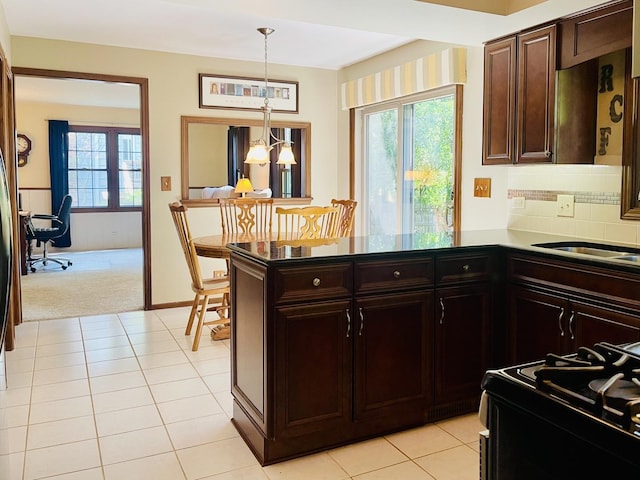 17581 W Summit Dr, Grayslake, IL 60030 - kitchen featuring gas stove, light carpet, decorative light fixtures, a peninsula, and a chandelier