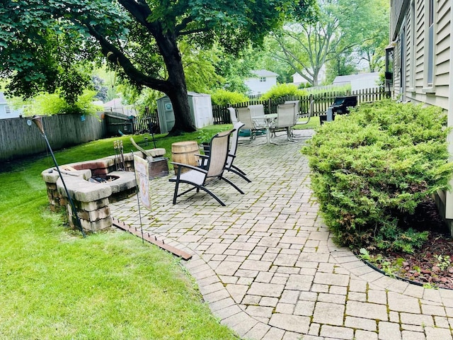 17581 W Summit Dr, Grayslake, IL 60030 - fenced backyard with an outdoor fire pit, a storage unit, a patio area, and outdoor dining area