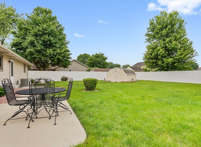 28 Old Farm S Ct, Bradley, IL 60915 - fenced backyard with a storage shed, a patio, and outdoor dining area