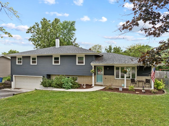 6130 Belmont Rd, Downers Grove, IL 60516 - split level home featuring asphalt driveway, a chimney, an attached garage, and brick siding