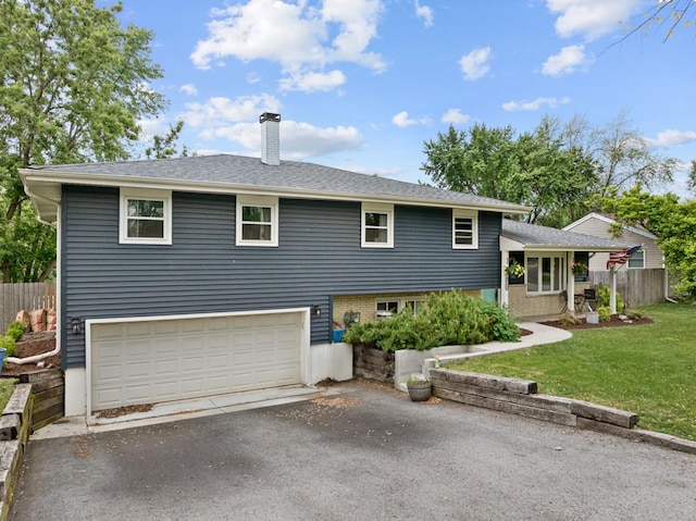6130 Belmont Rd, Downers Grove, IL 60516 - split level home with a chimney, asphalt driveway, and a garage