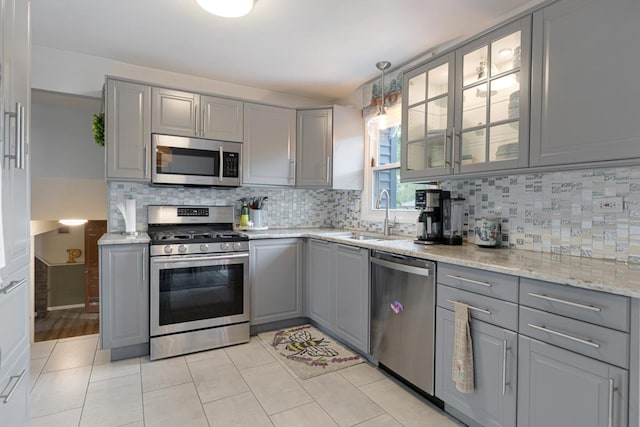 6130 Belmont Rd, Downers Grove, IL 60516 - kitchen with gray cabinets, appliances with stainless steel finishes, a sink, and backsplash