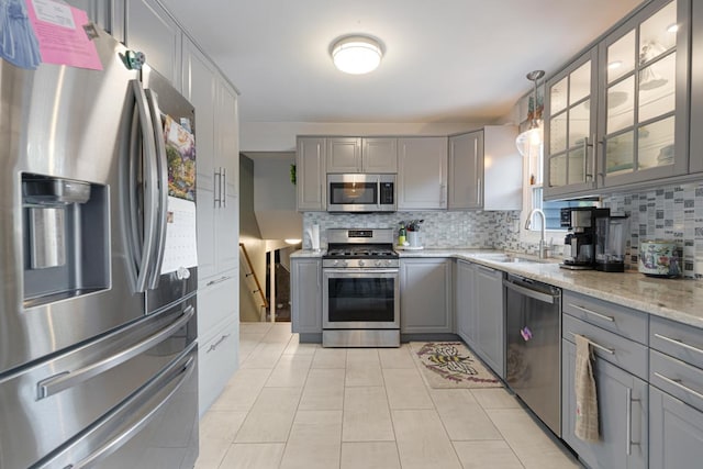 6130 Belmont Rd, Downers Grove, IL 60516 - kitchen with appliances with stainless steel finishes, gray cabinets, decorative backsplash, and a sink