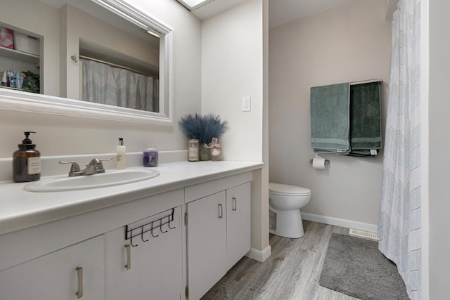 6130 Belmont Rd, Downers Grove, IL 60516 - bathroom featuring vanity, wood finished floors, toilet, and baseboards