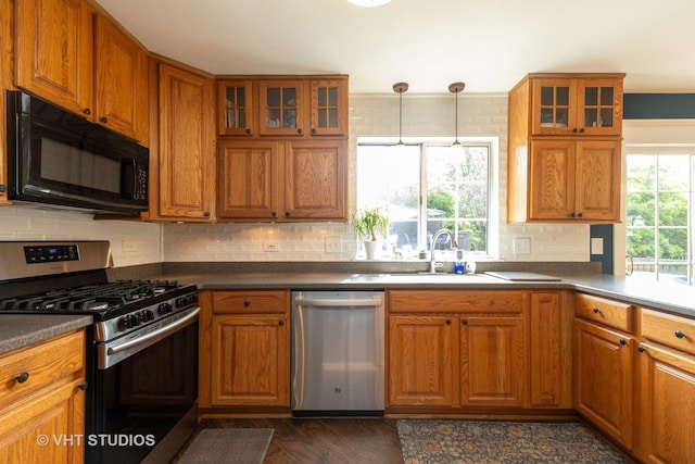 1544 Birmingham Ln, Crystal Lake, IL 60014 - kitchen with appliances with stainless steel finishes, brown cabinets, dark countertops, and decorative backsplash