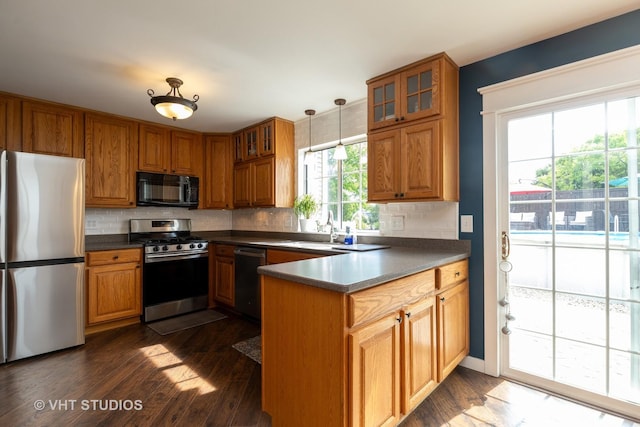 1544 Birmingham Ln, Crystal Lake, IL 60014 - kitchen with stainless steel appliances, a peninsula, brown cabinetry, dark countertops, and tasteful backsplash