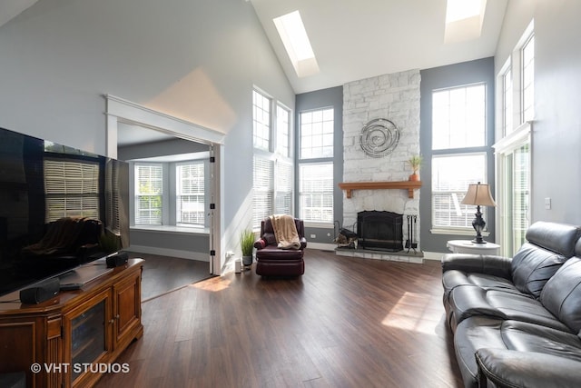 1544 Birmingham Ln, Crystal Lake, IL 60014 - living area featuring a stone fireplace, high vaulted ceiling, dark wood-style flooring, plenty of natural light, and a skylight