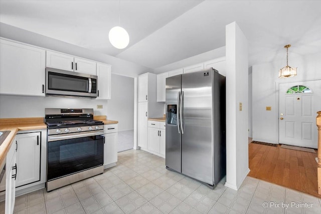2121 Baldwin Ln, Hanover Park, IL 60133 - kitchen with appliances with stainless steel finishes, light countertops, white cabinets, and decorative light fixtures