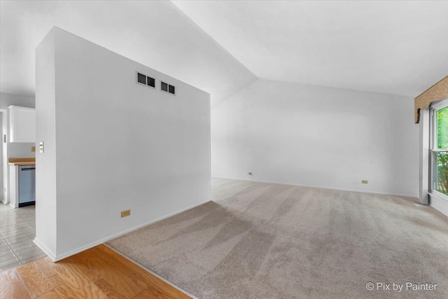 2121 Baldwin Ln, Hanover Park, IL 60133 - unfurnished living room featuring vaulted ceiling and carpet flooring