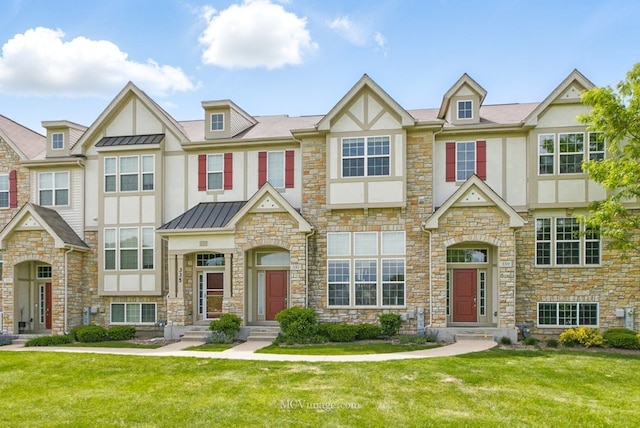 337 Bennett Dr, Carol Stream, IL 60188 - view of front facade featuring stucco siding, stone siding, a standing seam roof, and a front lawn