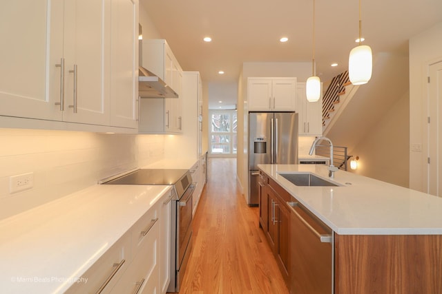 6123 S Ellis Ave, Chicago, IL 60637 - kitchen featuring stainless steel appliances, a sink, light wood-style floors, white cabinets, and recessed lighting
