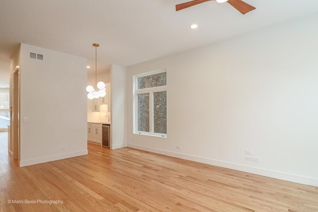 6123 S Ellis Ave, Chicago, IL 60637 - unfurnished room featuring light wood-style floors, baseboards, a ceiling fan, a sink, and recessed lighting
