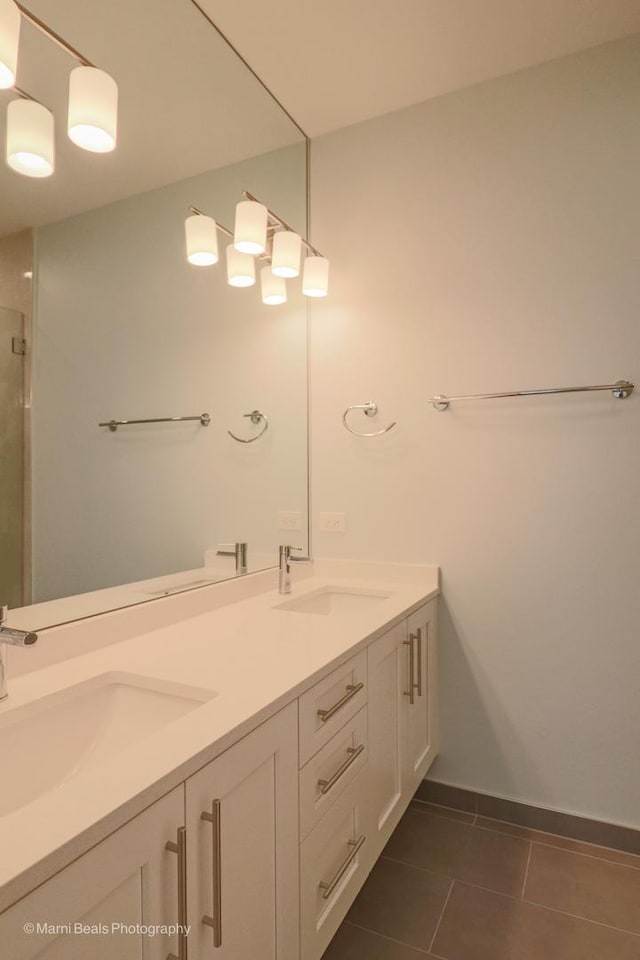 6123 S Ellis Ave, Chicago, IL 60637 - full bathroom with double vanity, tile patterned flooring, a shower stall, and baseboards