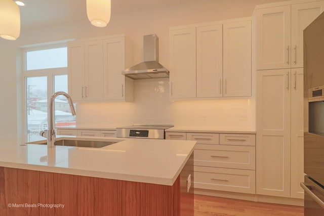 6123 S Ellis Ave, Chicago, IL 60637 - kitchen with wall chimney range hood, a sink, light countertops, stove, and recessed lighting