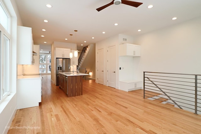 6123 S Ellis Ave, Chicago, IL 60637 - kitchen featuring a sink, a ceiling fan, light wood-style flooring, light countertops, and a center island with sink