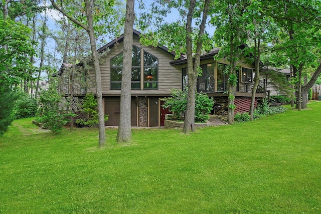 9316 Pine Needle Pass, Bull Valley, IL 60097 - back of house featuring a sunroom, a yard, stone siding, and a deck