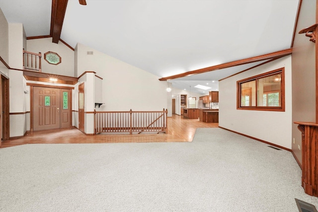 9316 Pine Needle Pass, Bull Valley, IL 60097 - unfurnished living room featuring light colored carpet, high vaulted ceiling, and beamed ceiling
