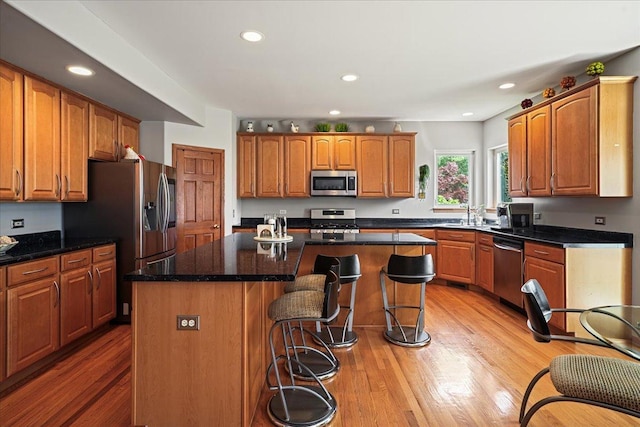 1839 Kings Gate Ln, Crystal Lake, IL 60014 - kitchen with stainless steel appliances, a center island, a kitchen breakfast bar, recessed lighting, and light wood-style flooring