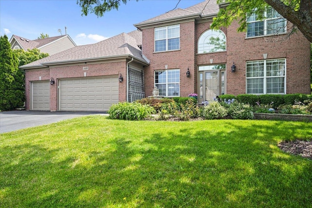 1839 Kings Gate Ln, Crystal Lake, IL 60014 - traditional-style house with brick siding, a garage, a front yard, driveway, and roof with shingles