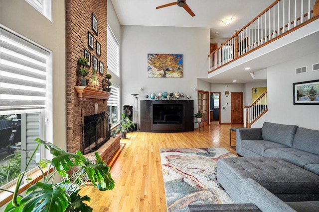 1839 Kings Gate Ln, Crystal Lake, IL 60014 - living area with a high ceiling, a fireplace, a ceiling fan, stairway, and wood finished floors