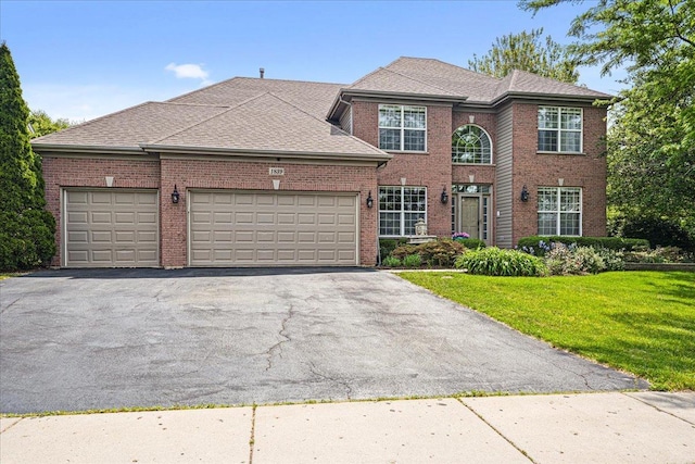 1839 Kings Gate Ln, Crystal Lake, IL 60014 - view of front of house featuring brick siding, an attached garage, driveway, and a front lawn