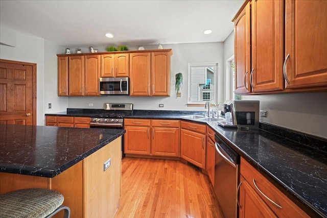 1839 Kings Gate Ln, Crystal Lake, IL 60014 - kitchen with appliances with stainless steel finishes, a sink, light wood-style flooring, dark stone countertops, and recessed lighting