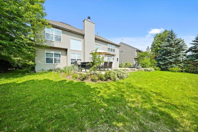 1839 Kings Gate Ln, Crystal Lake, IL 60014 - back of house featuring a chimney, a lawn, and a patio area