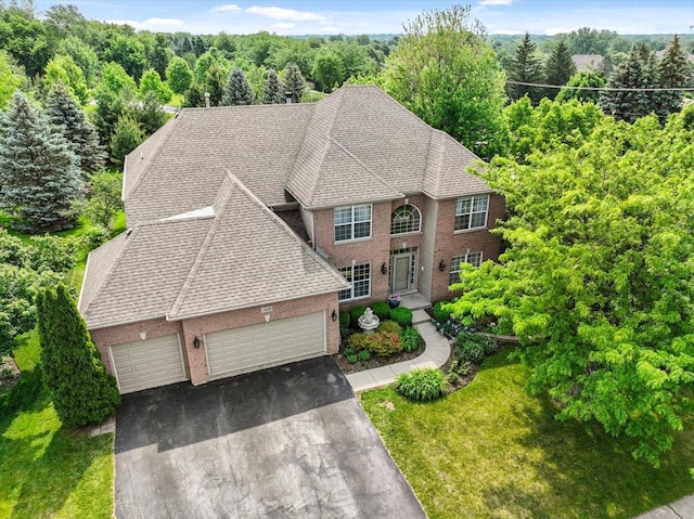 1839 Kings Gate Ln, Crystal Lake, IL 60014 - view of front of property featuring brick siding, a garage, roof with shingles, asphalt driveway, and a front lawn