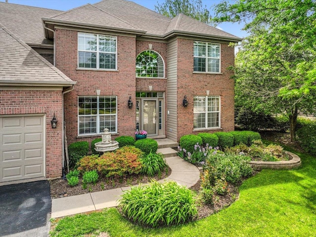 1839 Kings Gate Ln, Crystal Lake, IL 60014 - traditional-style house with brick siding, a shingled roof, and a front lawn
