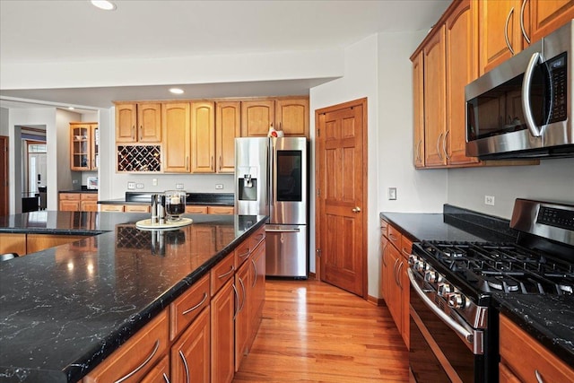 1839 Kings Gate Ln, Crystal Lake, IL 60014 - kitchen with stainless steel appliances, light wood finished floors, recessed lighting, dark stone counters, and glass insert cabinets