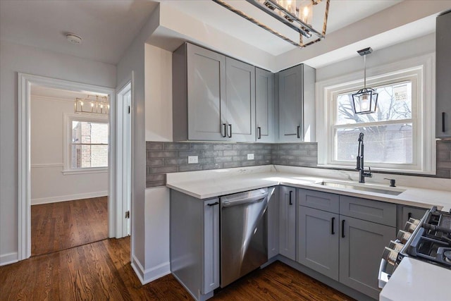 7241 N Kilpatrick Ave, Lincolnwood, IL 60712 - kitchen with gray cabinets, stainless steel dishwasher, a sink, and a chandelier
