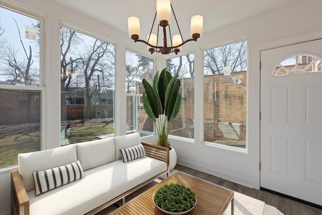 7241 N Kilpatrick Ave, Lincolnwood, IL 60712 - sunroom with healthy amount of natural light, a chandelier, and wood finished floors