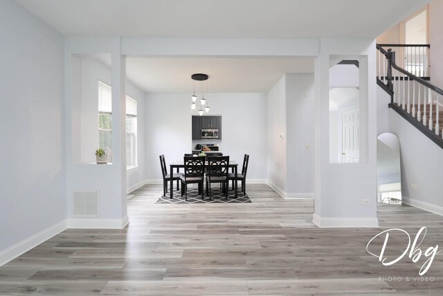1943 Lily Ln, Round Lake, IL 60073 - dining space featuring light wood-style flooring and stairway